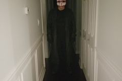 toothy mask in the hall